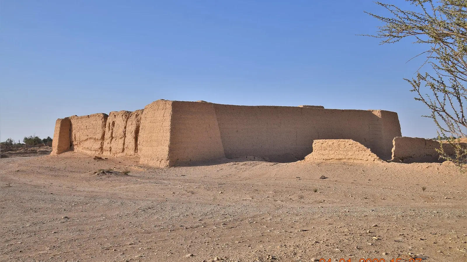 أطلال قصر الحسوات الأثري بجدرانه الطينية وسط الصحراء تحت سماء صافية