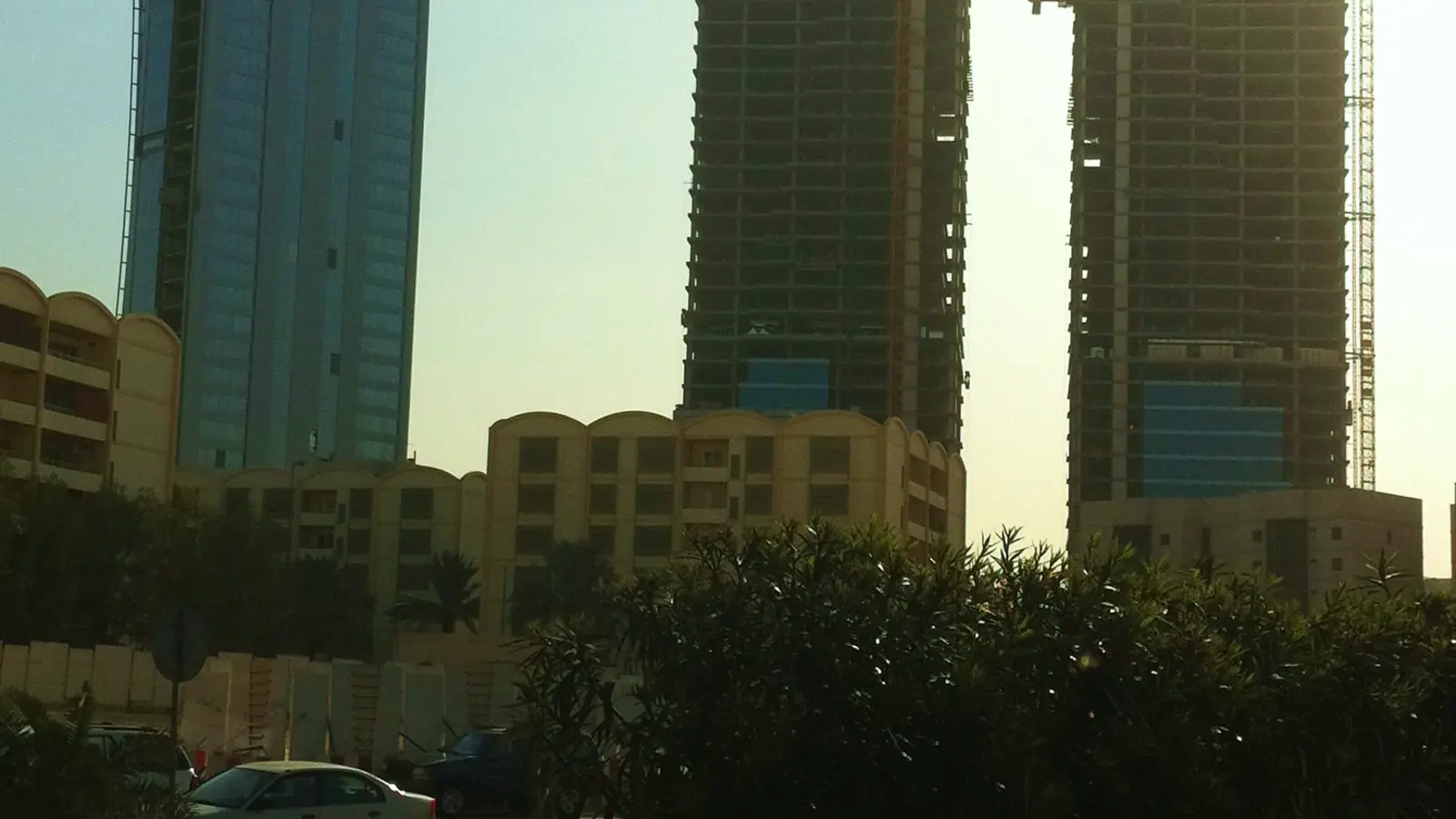 أبراج قيد الإنشاء في حي العليا بالرياض مع رافعات برجية، مشهد يعكس قطاعات تشغّل عمالة وافدة تحتاج رخص عمل