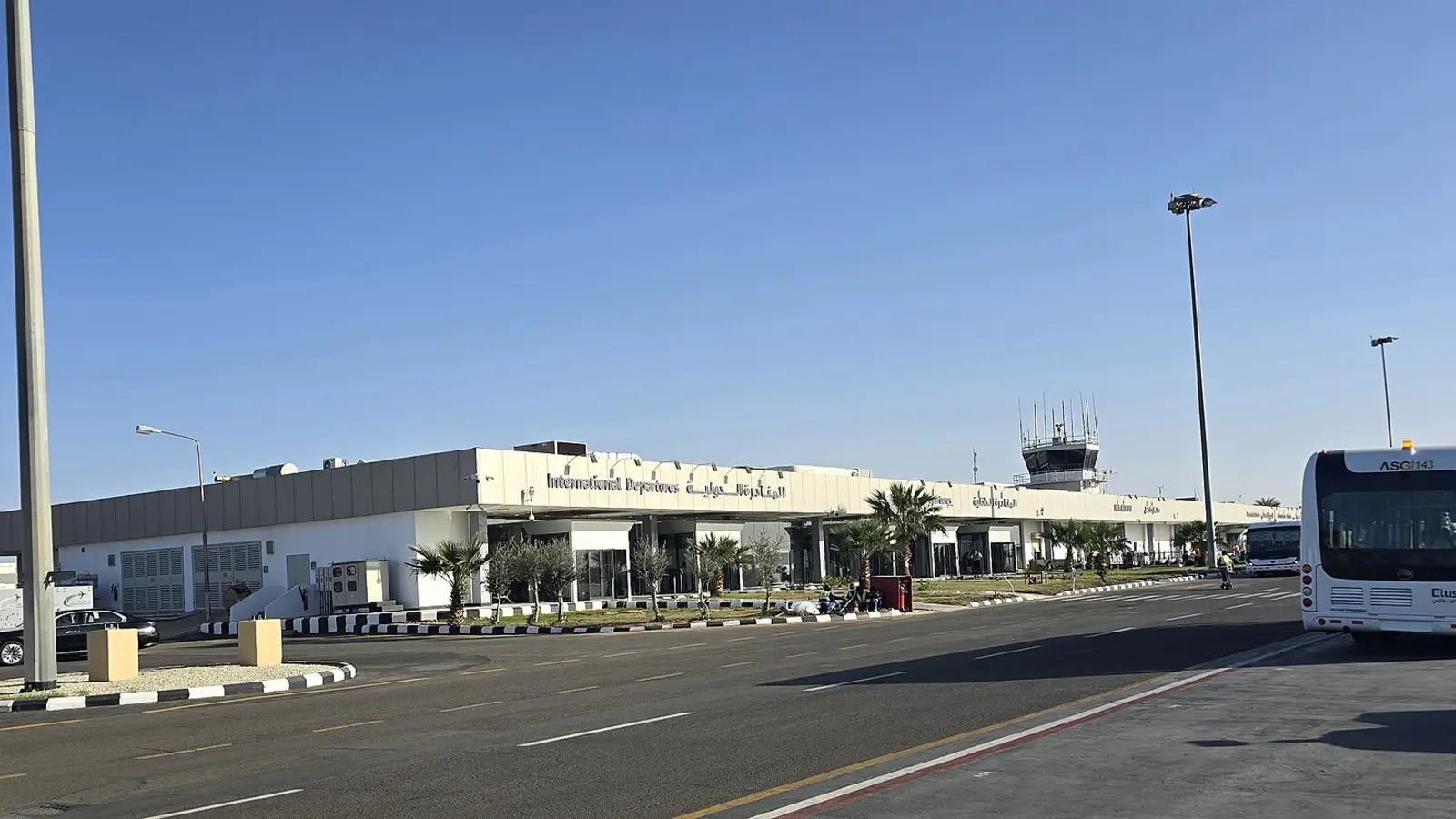 مبنى صالات المغادرات الدولية في مطار سعودي إقليمي وحافلة ركاب أمامه بلا مسافرين